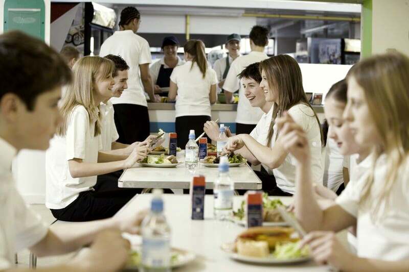 A school staff member supporting a pupil with a food allergy at lunchtime